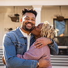 A happy couple shares a joyful embrace in their home.