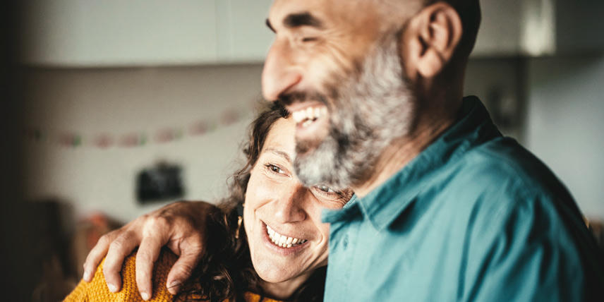 Man comforting someone with hand on shoulder indoors.