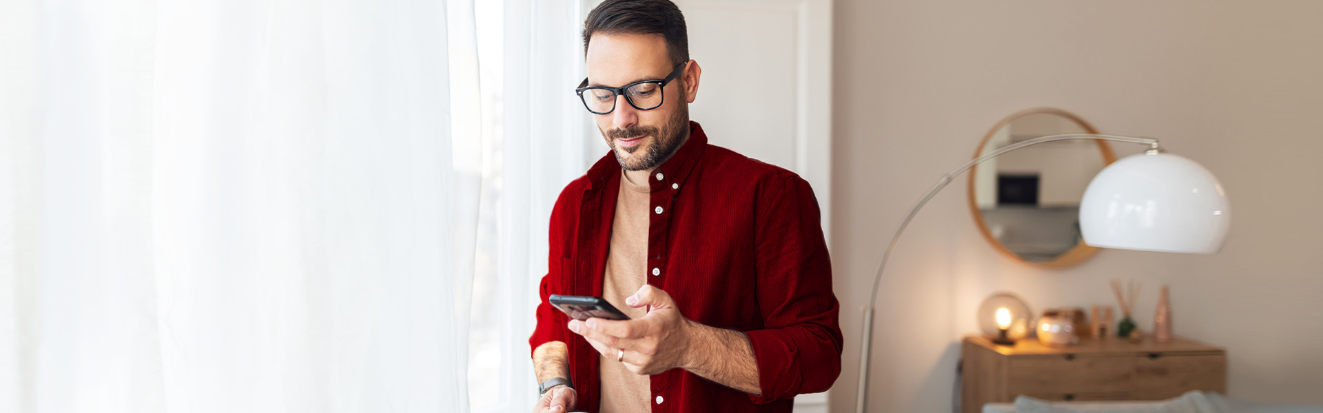 A man looking down on his phone.