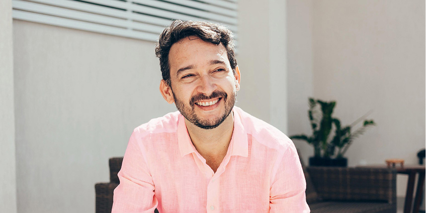 Smiling young man wearing pink shirt