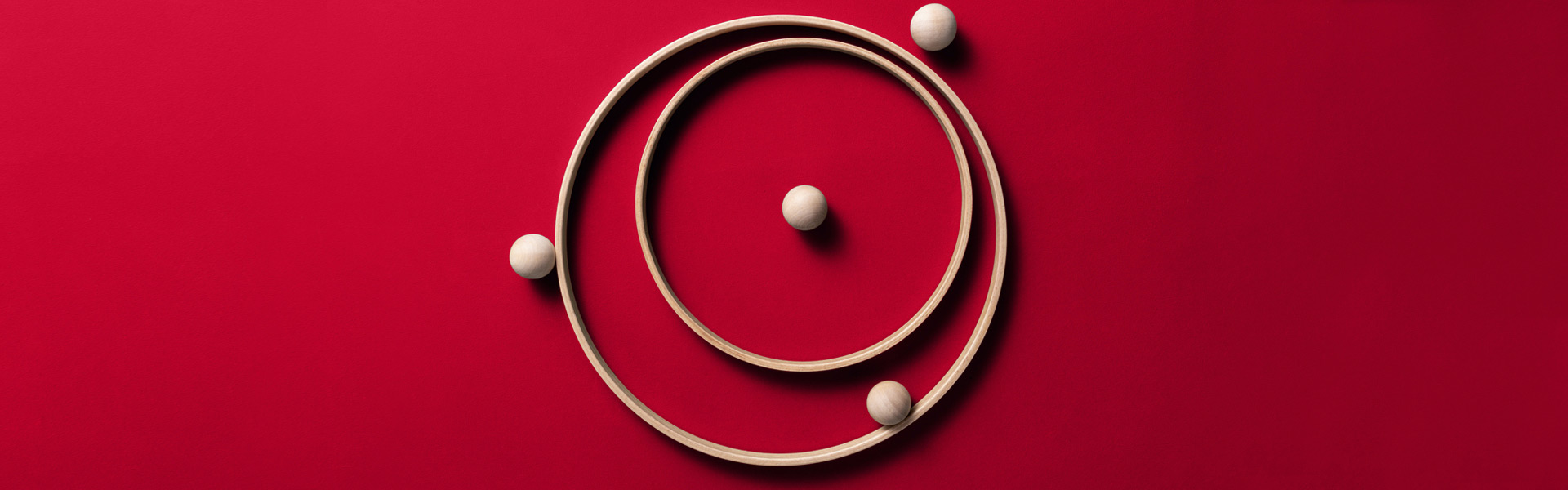 2 circles and with 4 balls located in various locations on red background