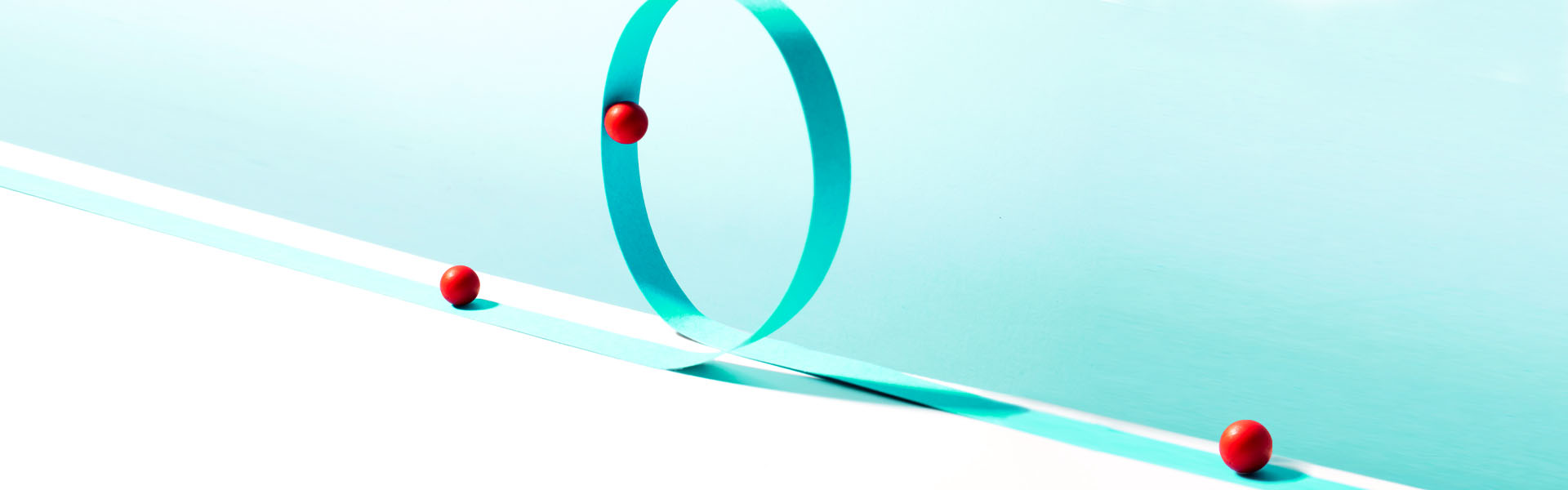 Abstract illustration of red dots traveling on aqua ribbon.