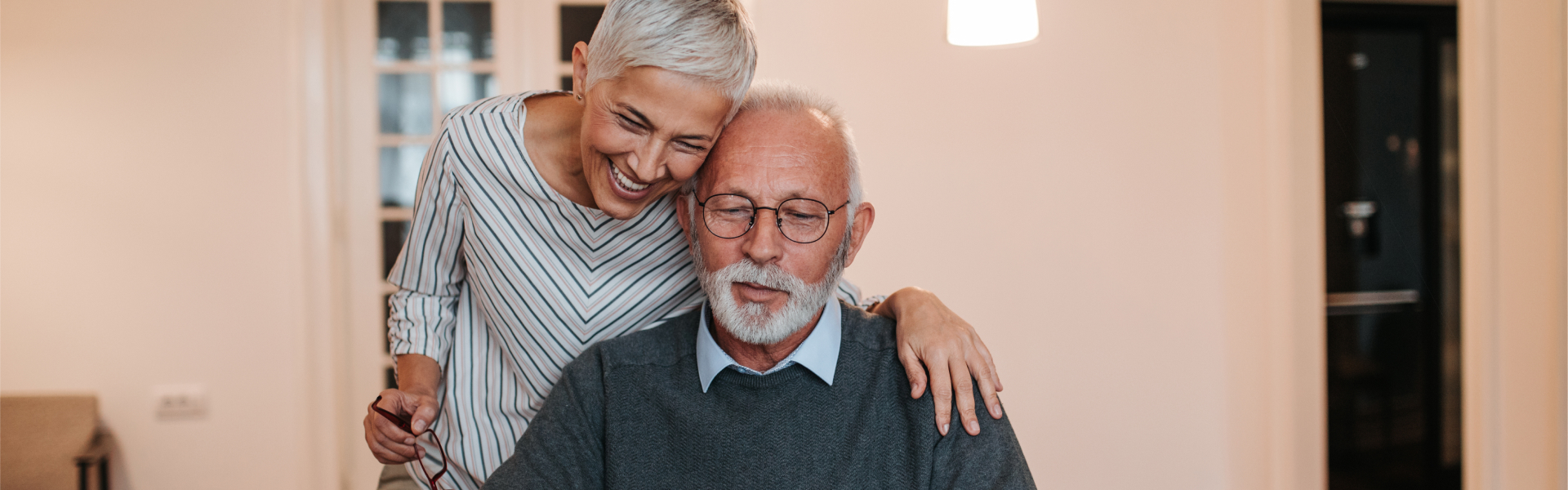 Older couple, reviewing information on a laptop.