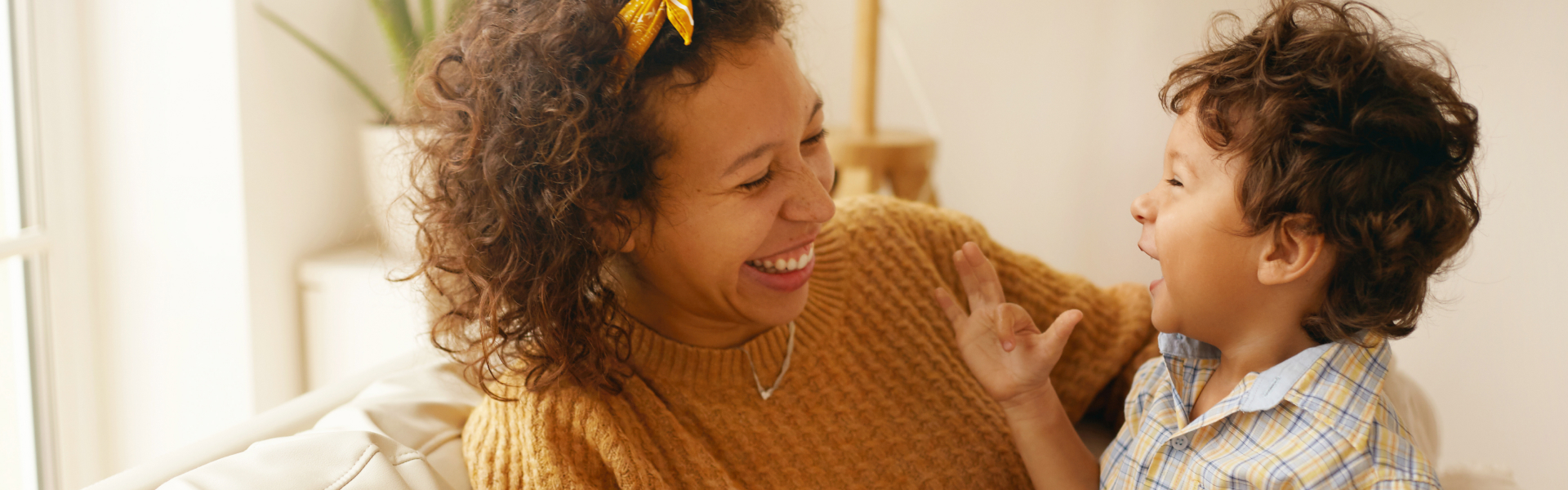 A woman is holding a laughing child.