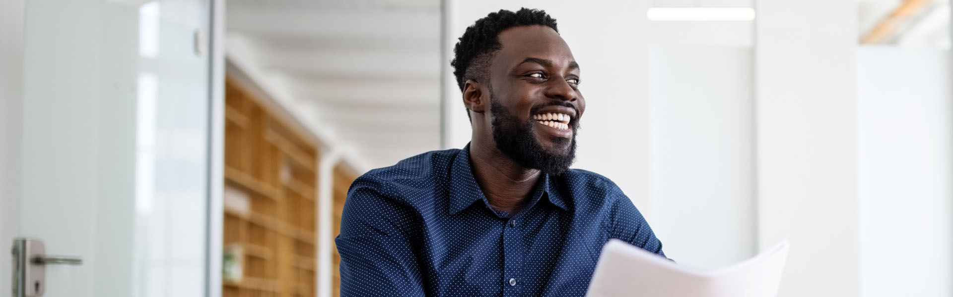 A man is smiling and looking to his left	