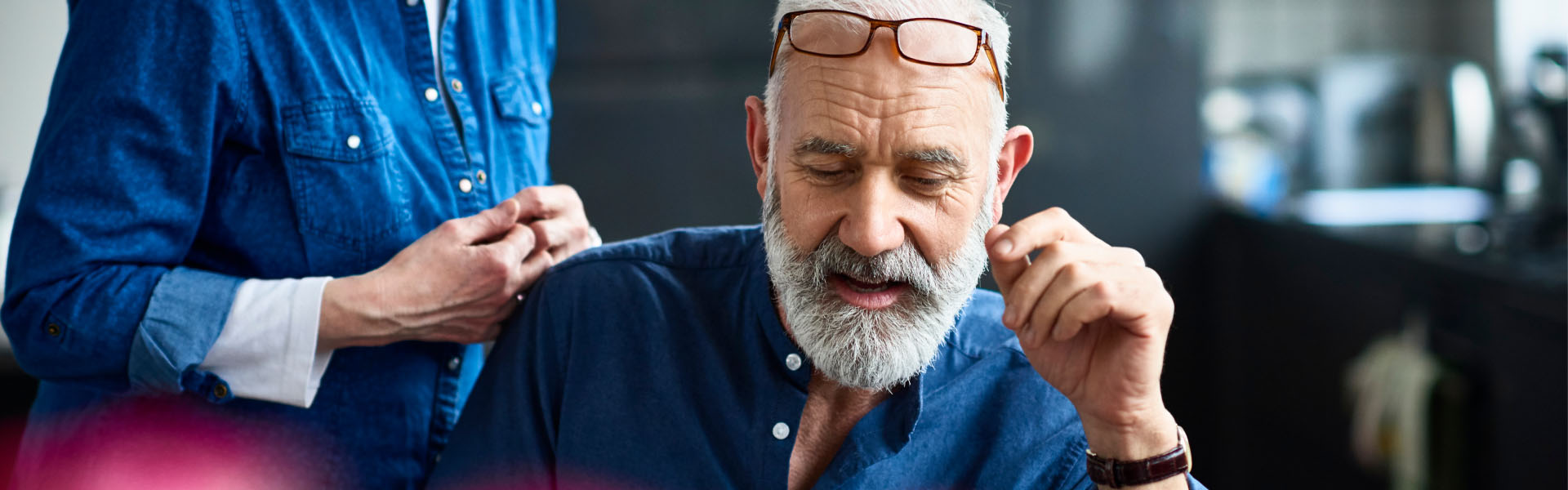 A man has his glasses perched on his head.