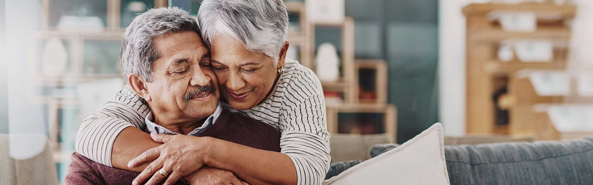 Older couple embracing.