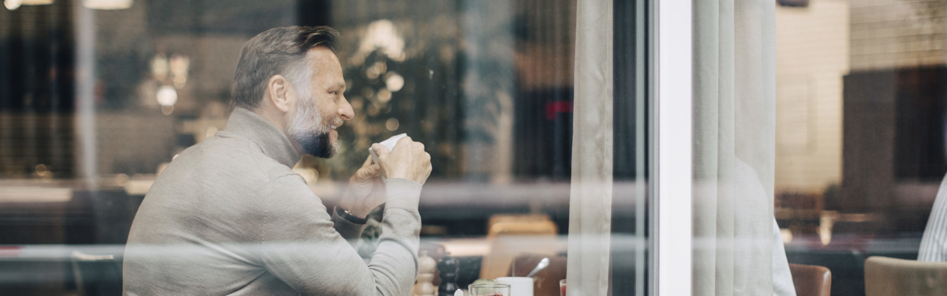 A man is holding a coffee mug.