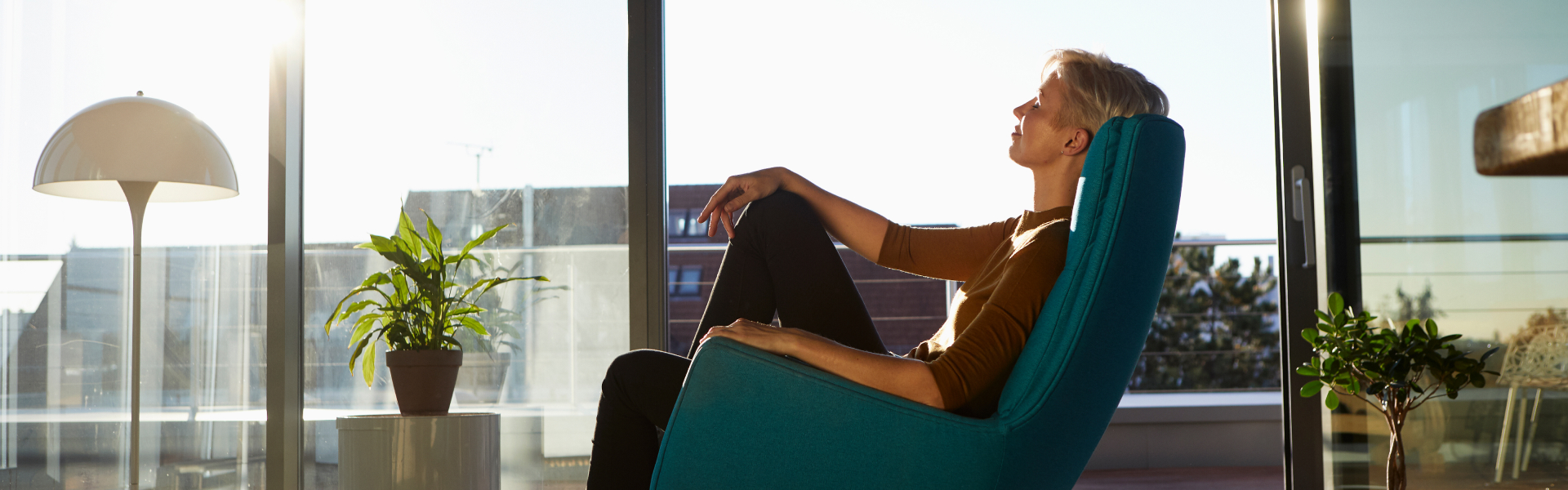 A woman is leaning back in a chair.