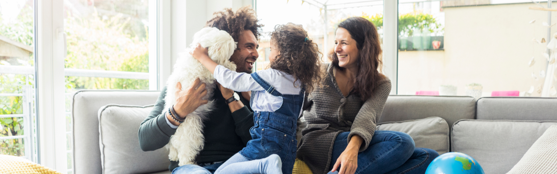 Two parents are laughing with their child.