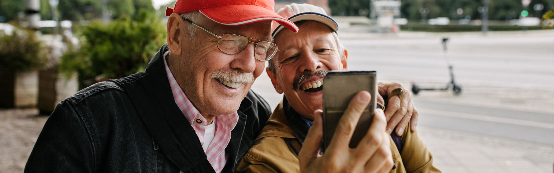 Two older men are smiling.