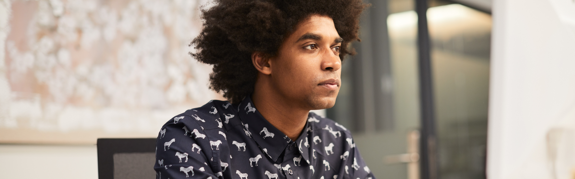 A young man is staring off at something out of the frame.	