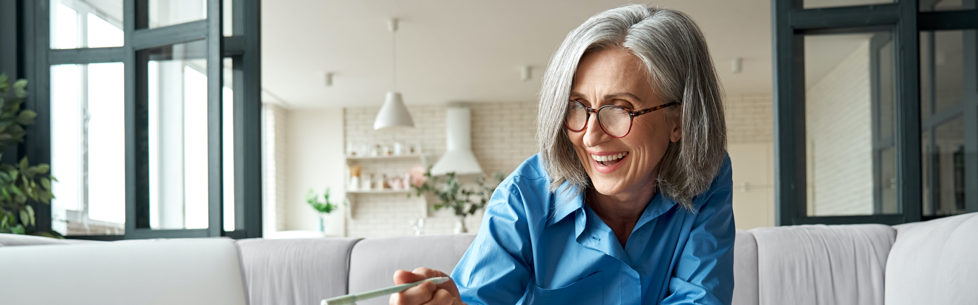 An older woman is laughing.