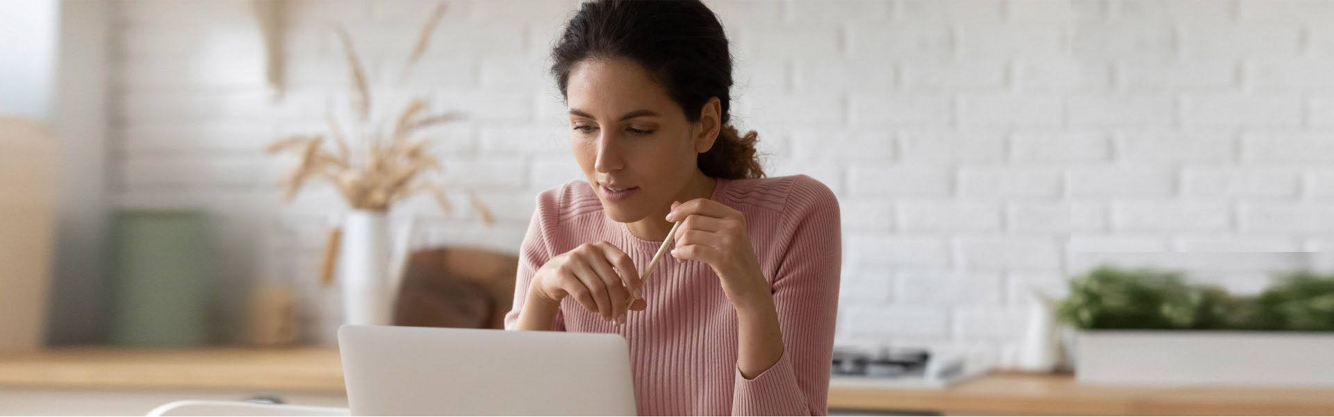 Woman on her laptop looking at her short-term savings account.