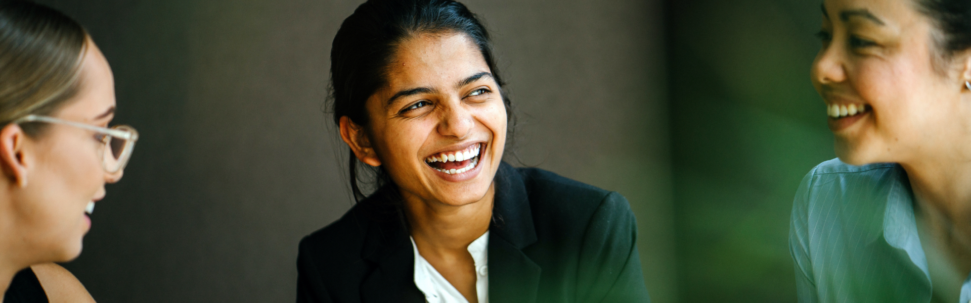 A group of women are smiling and laughing.