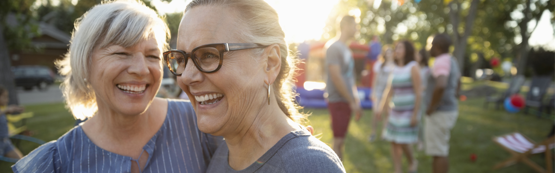 Two women are embracing and smiling.