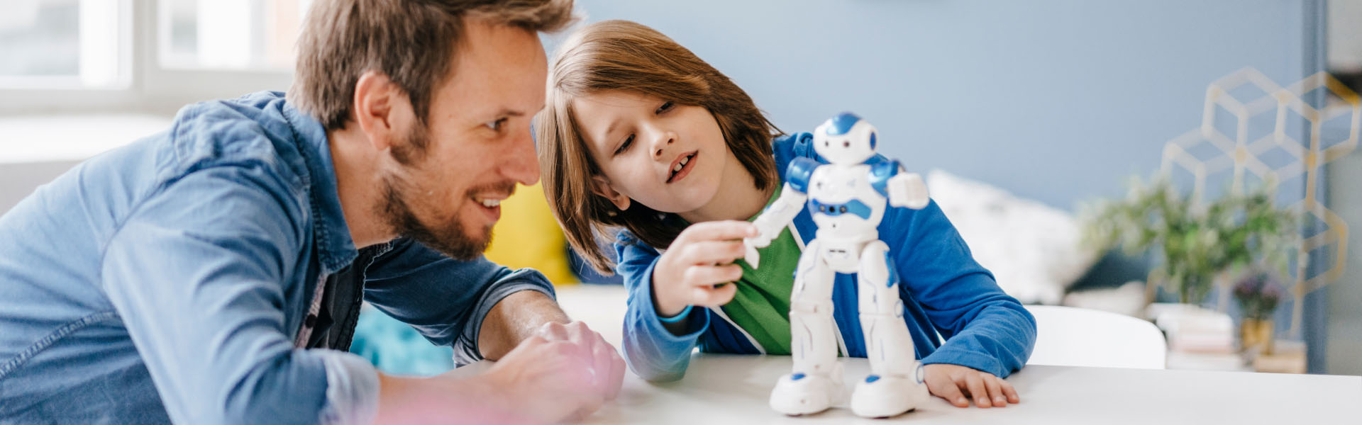 A young child is playing with a robot toy.	