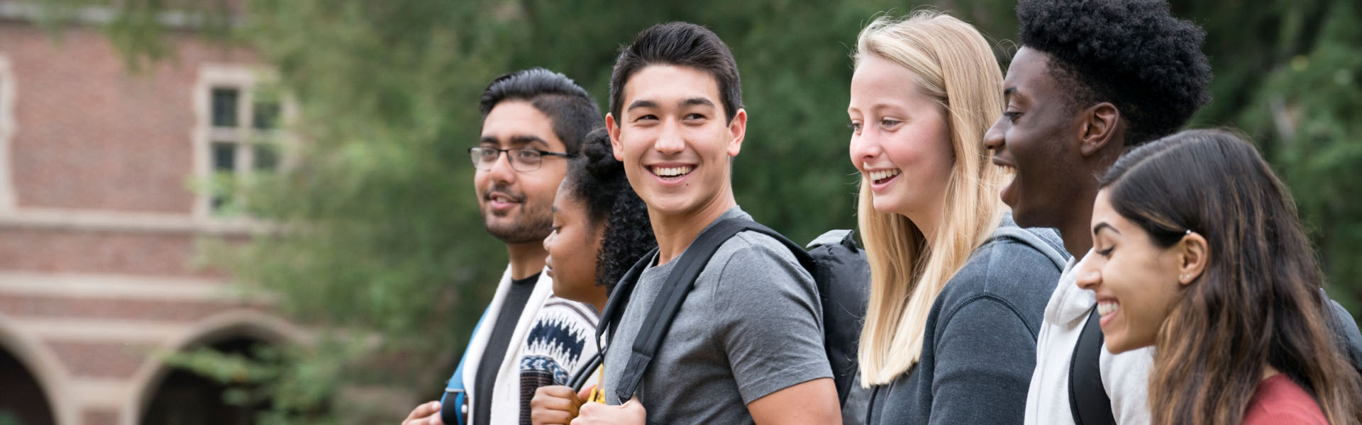 A group of young adults are smiling.	