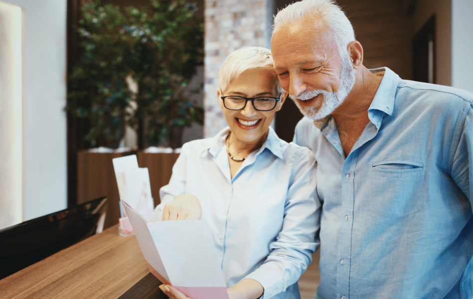 Older couple read a greeting card together.