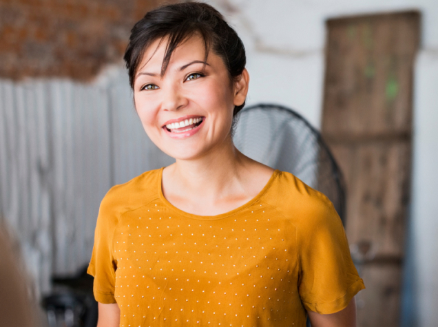 Woman smiling in self-directed advice image.