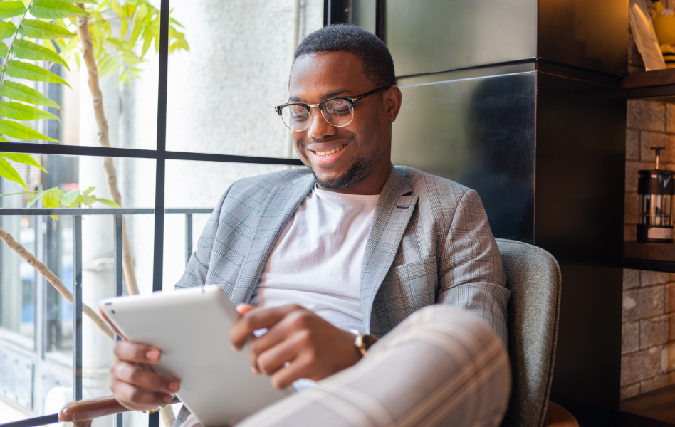 Guy sitting and looking at a tablet