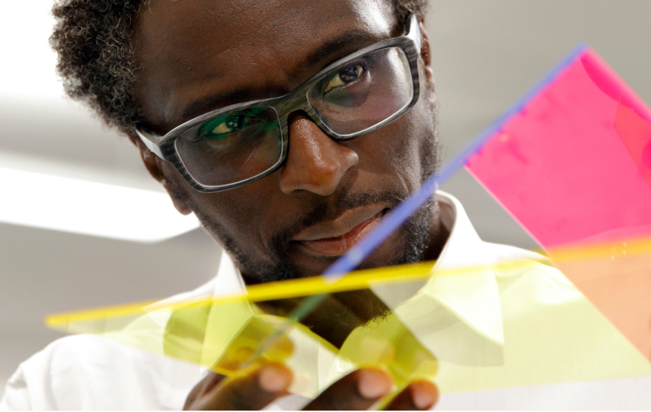 A young man is looking at an object in his hands.