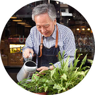 Shop keeper watering his plants