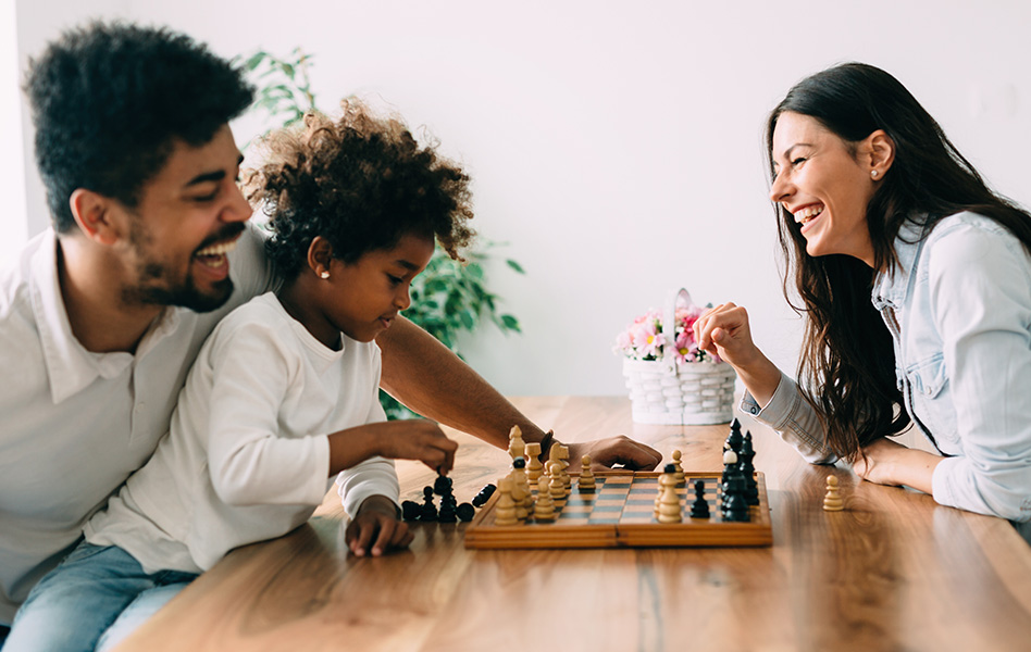 A family plays chess at a table.