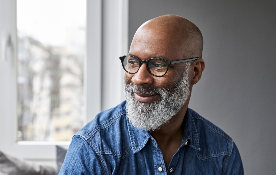 Man smiling while looking to his right.