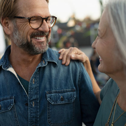 Man smiling at woman.