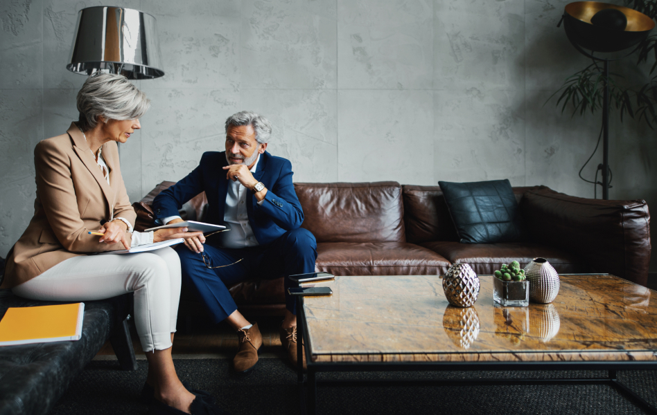 Man and woman have a business meeting in a corporate lounge.