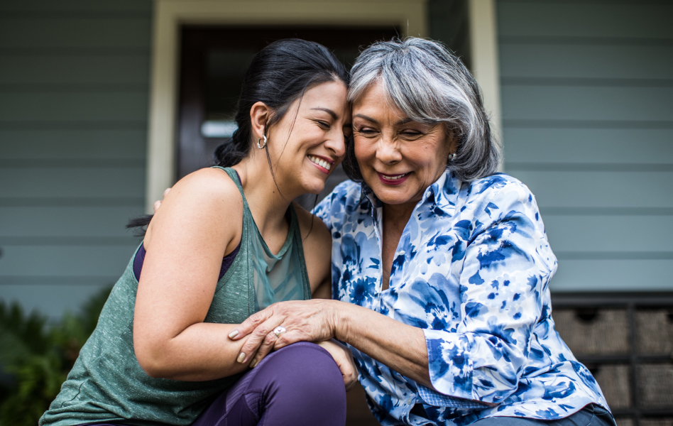 Older woman embracing her adult daughter.