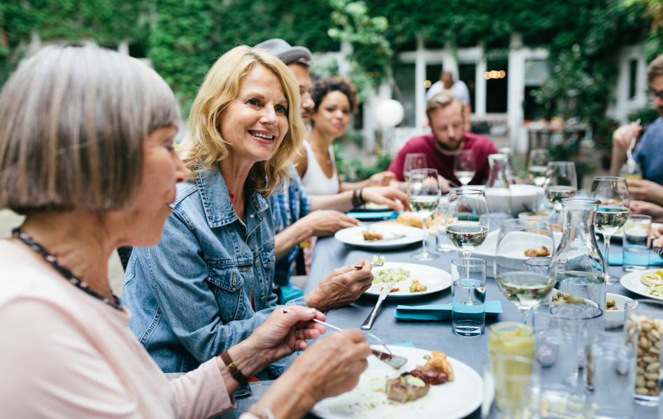 Woman enjoying an outdoor dinner with family.