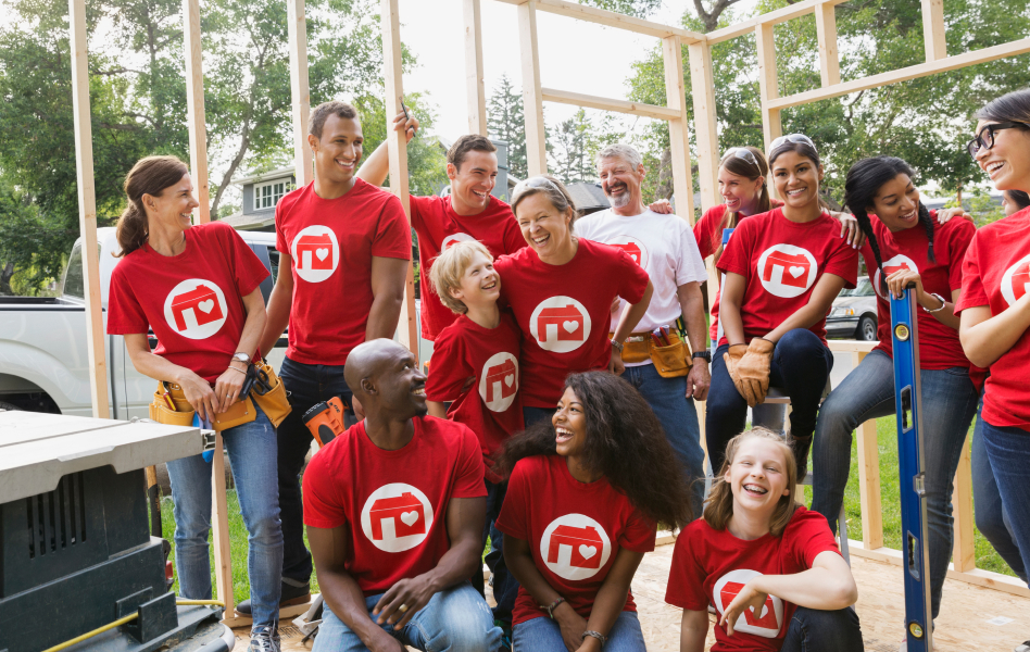 Large family posing after volunteering to build a house.